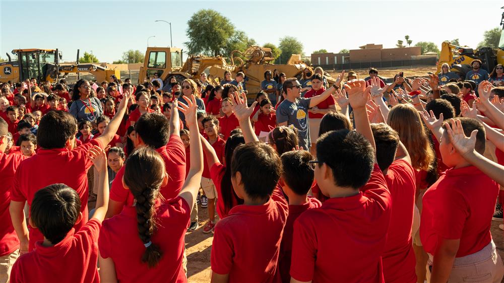 A group photo of students dressed in red polos